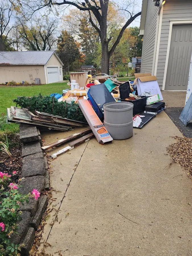 Dumpster being loaded with debris for 12 Yard Dumpster Rental in Worthington